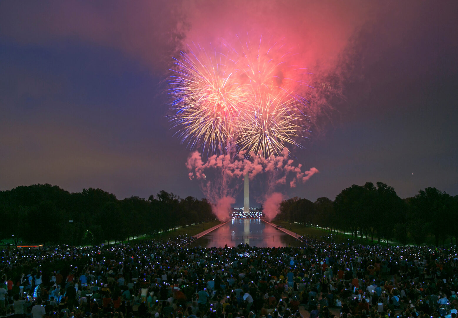 Spectators use their smart phones and cameras to document fireworks as they explode over the National Mall in Washington on July 4, 2015.