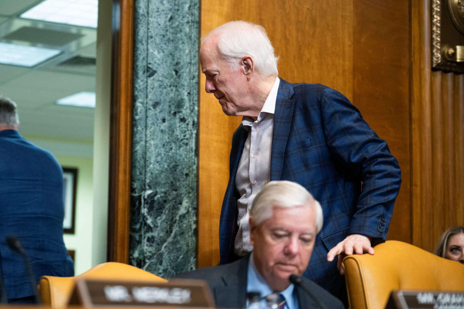 Sen. John Cornyn, R-Texas, walks behind Sen. Lindsey Graham, R-S.C., at a markup on May 20. President Donald Trump endorsed Cornyn’s opponent in the Republican primary. (Tom Williams/CQ Roll Call)
