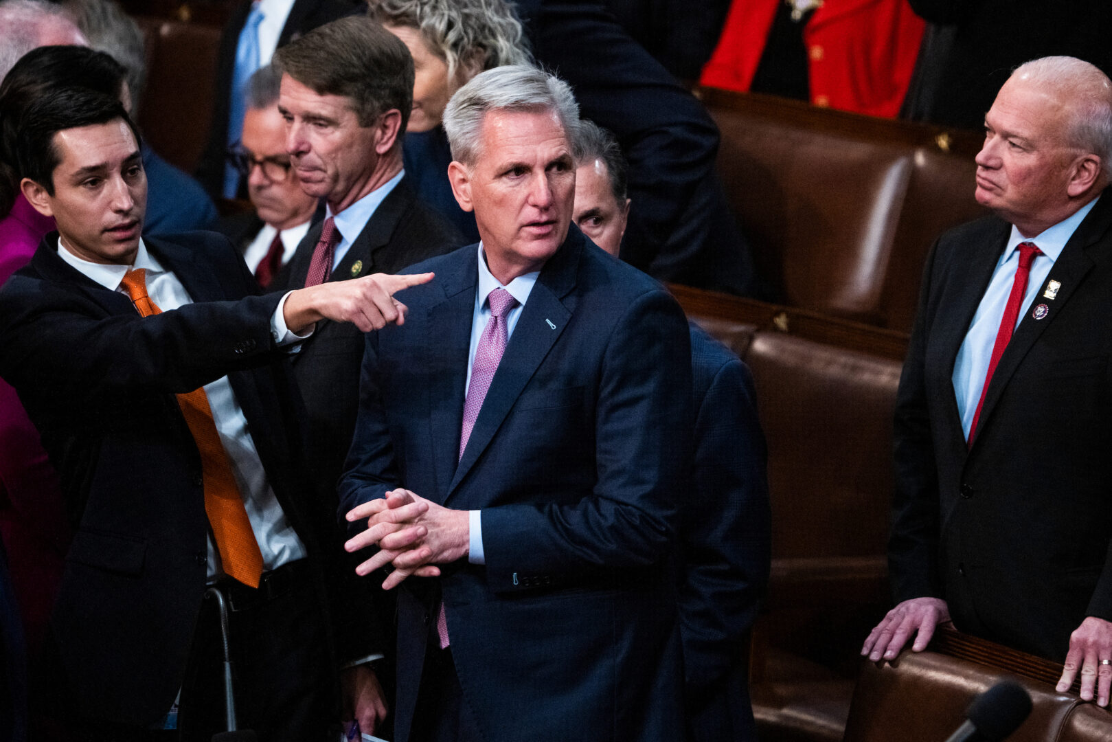Then-staffer John Leganski points past his boss, Kevin McCarthy, during a speaker vote on Jan. 6, 2023. His bright orange tie briefly became a meme as the nation watched historic scenes of uncertainty play out on the House floor that week.
