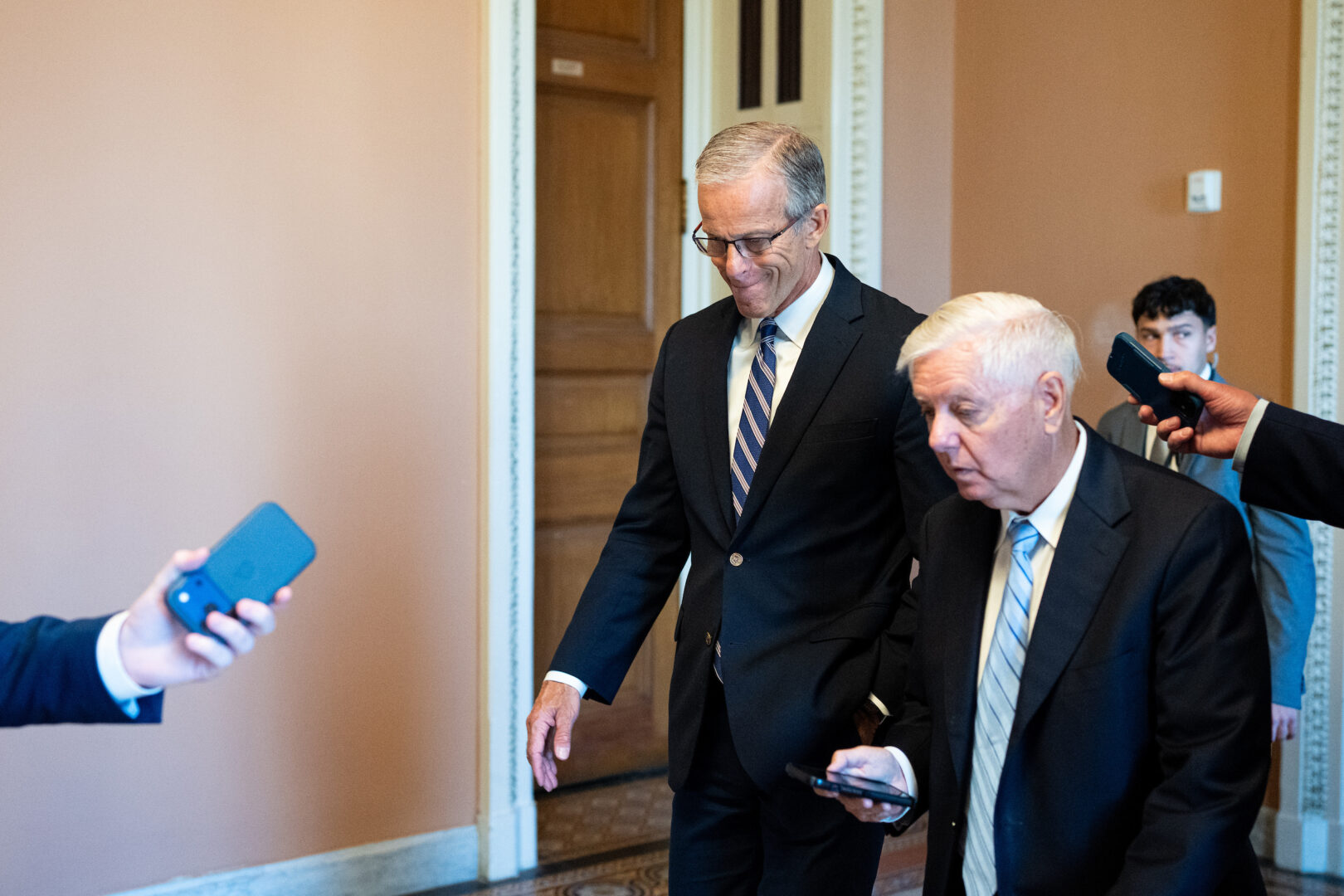 Senate Majority Leader John Thune, R-S.D., left, and Sen. Lindsey Graham, R-S.C., walk to the Senate chamber Thursday during the reconciliation vote-a-rama. 