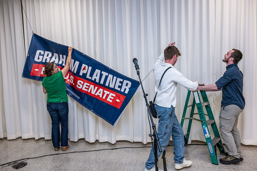 Campaign workers erect signs before a Graham Platner event in Portland, Maine, on June 7. Now the state party is scrambling to find a replacement.