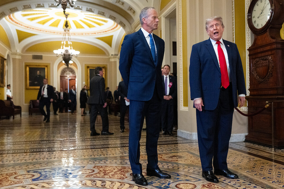 Senate Majority Leader John Thune, R-S.D., listens as President Donald Trump speaks to the media as he arrives for a Senate GOP lunch meeting in the Capitol on June 24.