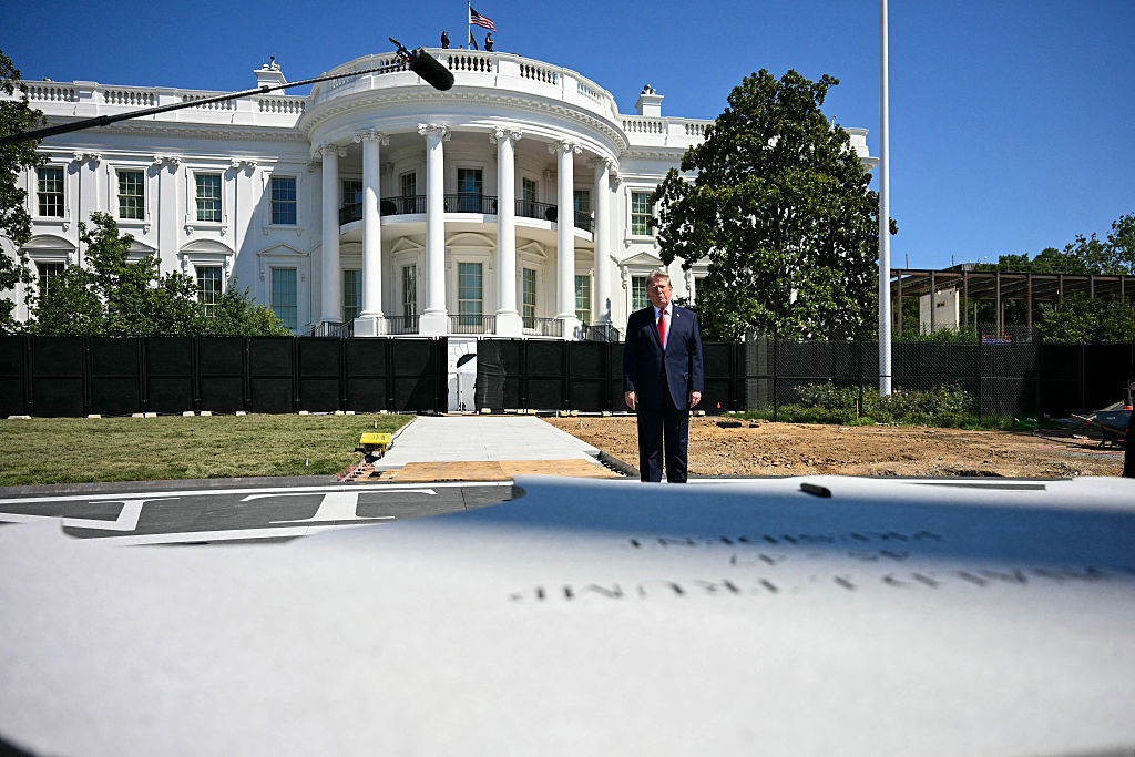 President Donald Trump looks on before signing a piece of stone at the construction site of a helipad on the South Lawn of the White House on Wednesday. (Jim Watson/AFP via Getty Images)