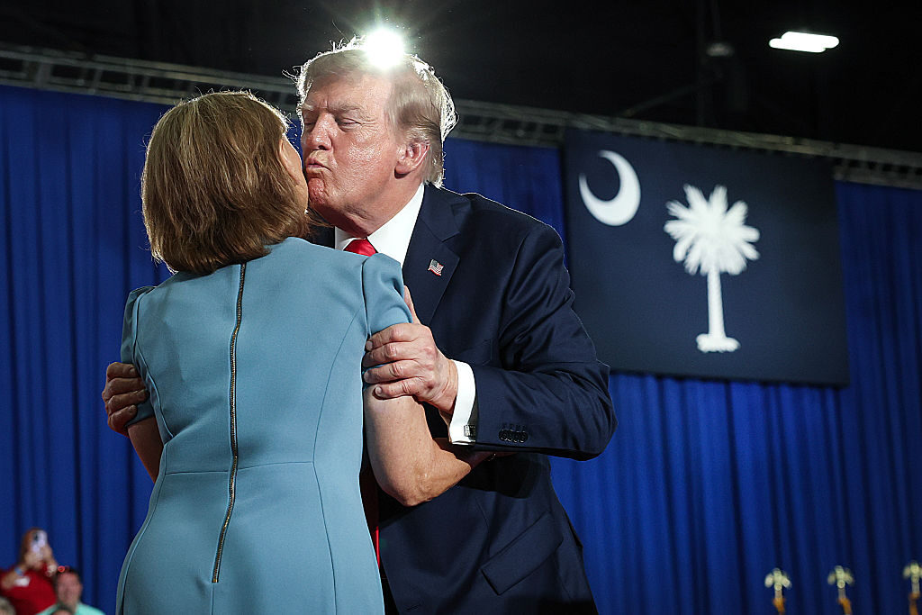 President Donald Trump greets Sen. Darline Graham, R-S.C., during a campaign rally on Friday in Myrtle Beach, S.C.