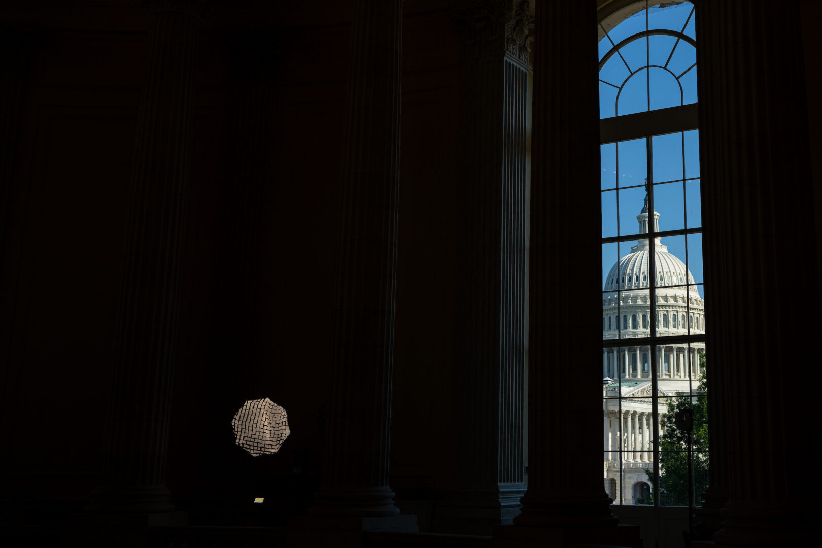 The Capitol dome is seen through a window in the Cannon House Office Building this spring.