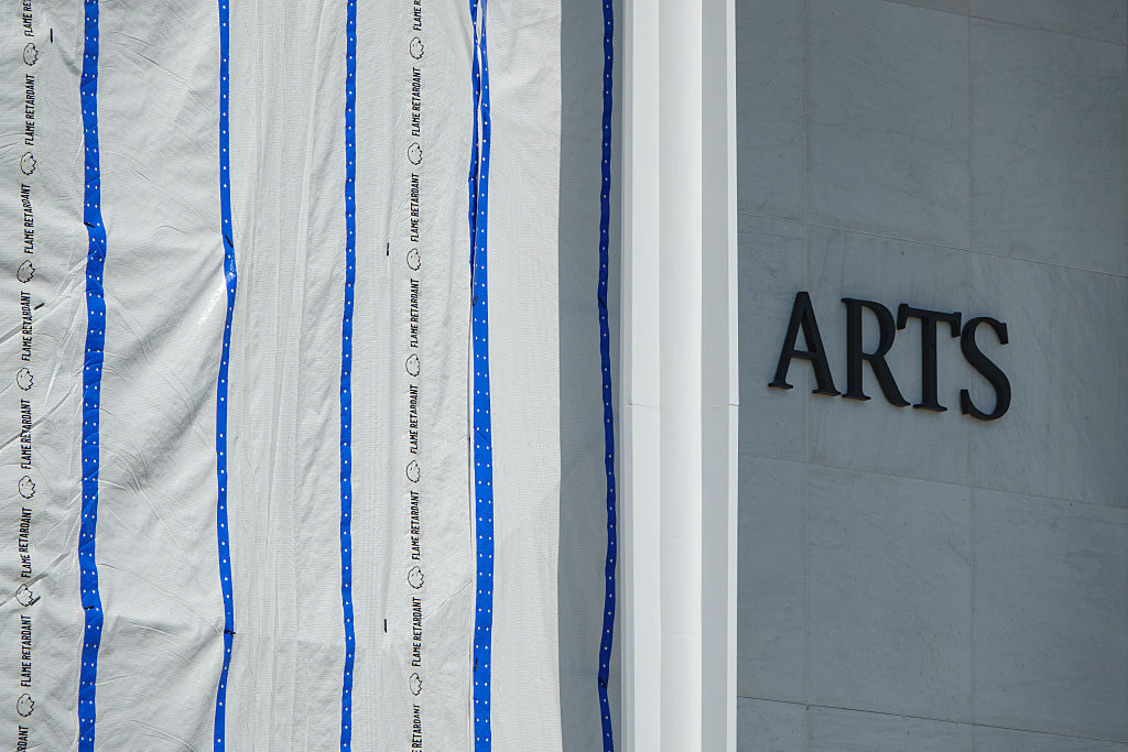 A scaffolding with a tarp stands in front of the Kennedy Center in August, covering the place where President Donald Trump's name was removed. 