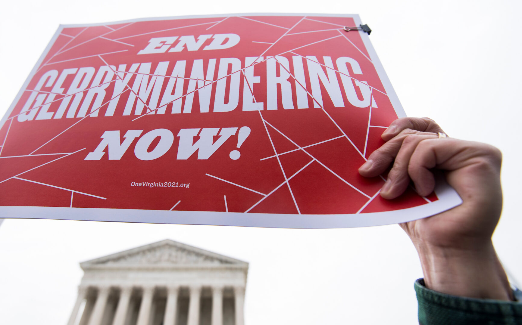 Redistricting may be a high-stakes topic, but it can sometimes make people’s eyes “glaze over,” the authors of a new book say. Above, anti-gerrymandering activists are seen outside the Supreme Court in 2018.