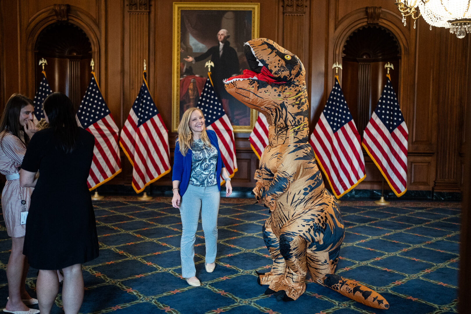 Rep. Erin Houchin, R-Ind., prepares to film a video with a man in a Tyrannosaurus rex costume to mark to the passage of the National Fossil Act in the U.S. Capitol on Thursday. (Tom Williams/CQ Roll Call)