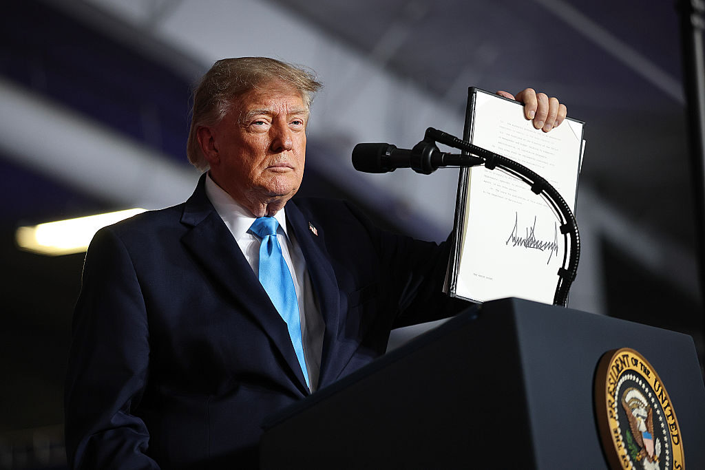 President Donald Trump signs an executive order he said would lower the cost of diesel fuel at a rally Tuesday in Nebraska. (Win McNamee/Getty Images)