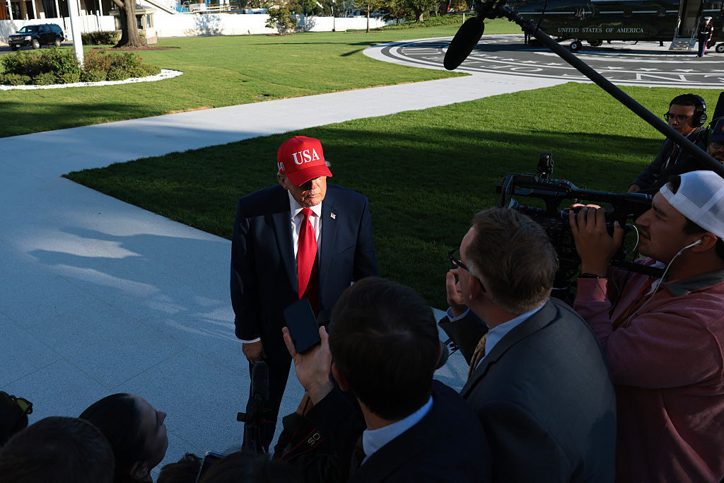 President Donald Trump listens to a question from CQ Roll Call's John T. Bennett as he returned to the White House on Tuesday evening. (Anna Moneymaker/Getty Images)