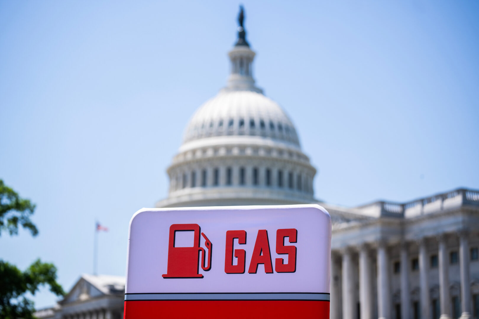 A sign referencing high gas prices is seen at an event outside the Capitol in May.